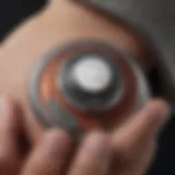 A close-up view of an Apple AirTag attached to a personal item, showcasing its sleek design.