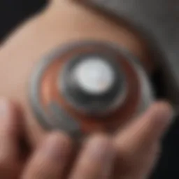 A close-up view of an Apple AirTag attached to a personal item, showcasing its sleek design.