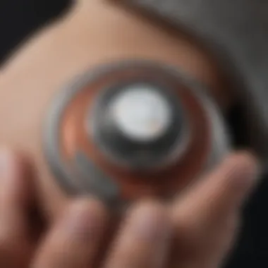A close-up view of an Apple AirTag attached to a personal item, showcasing its sleek design.